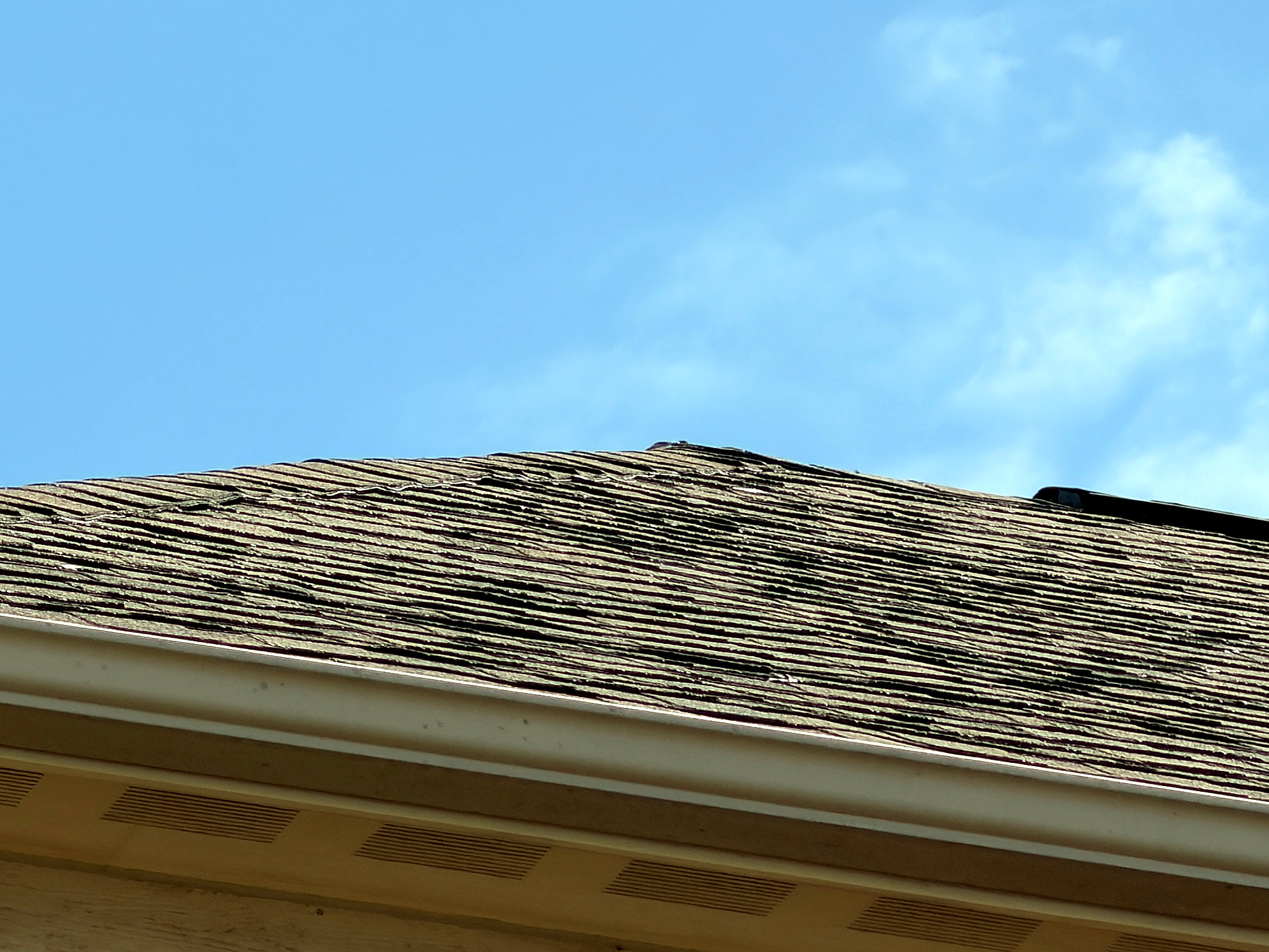 Lifted, wavy shingles before tear-off