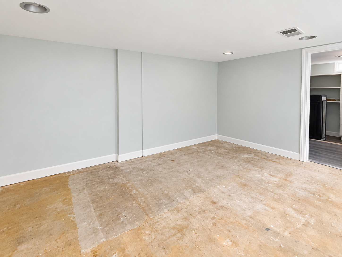 The room before — bare walls and subfloor