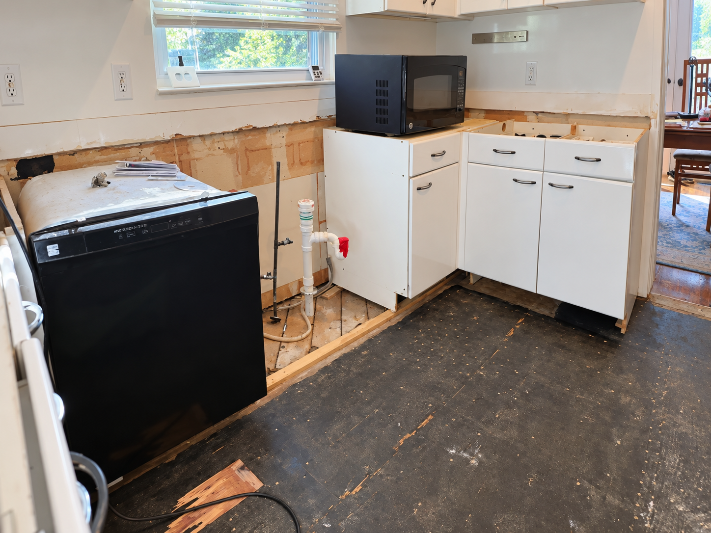 Plumbing exposed with the old cabinets out