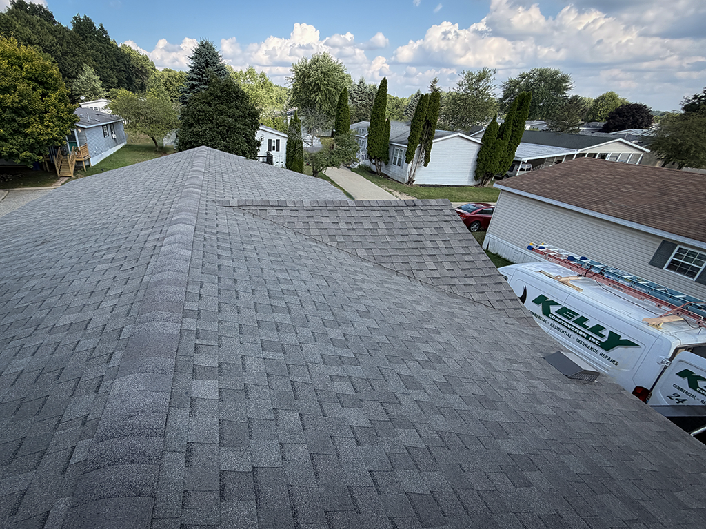 Kelly Construction crew member installing roofing materials