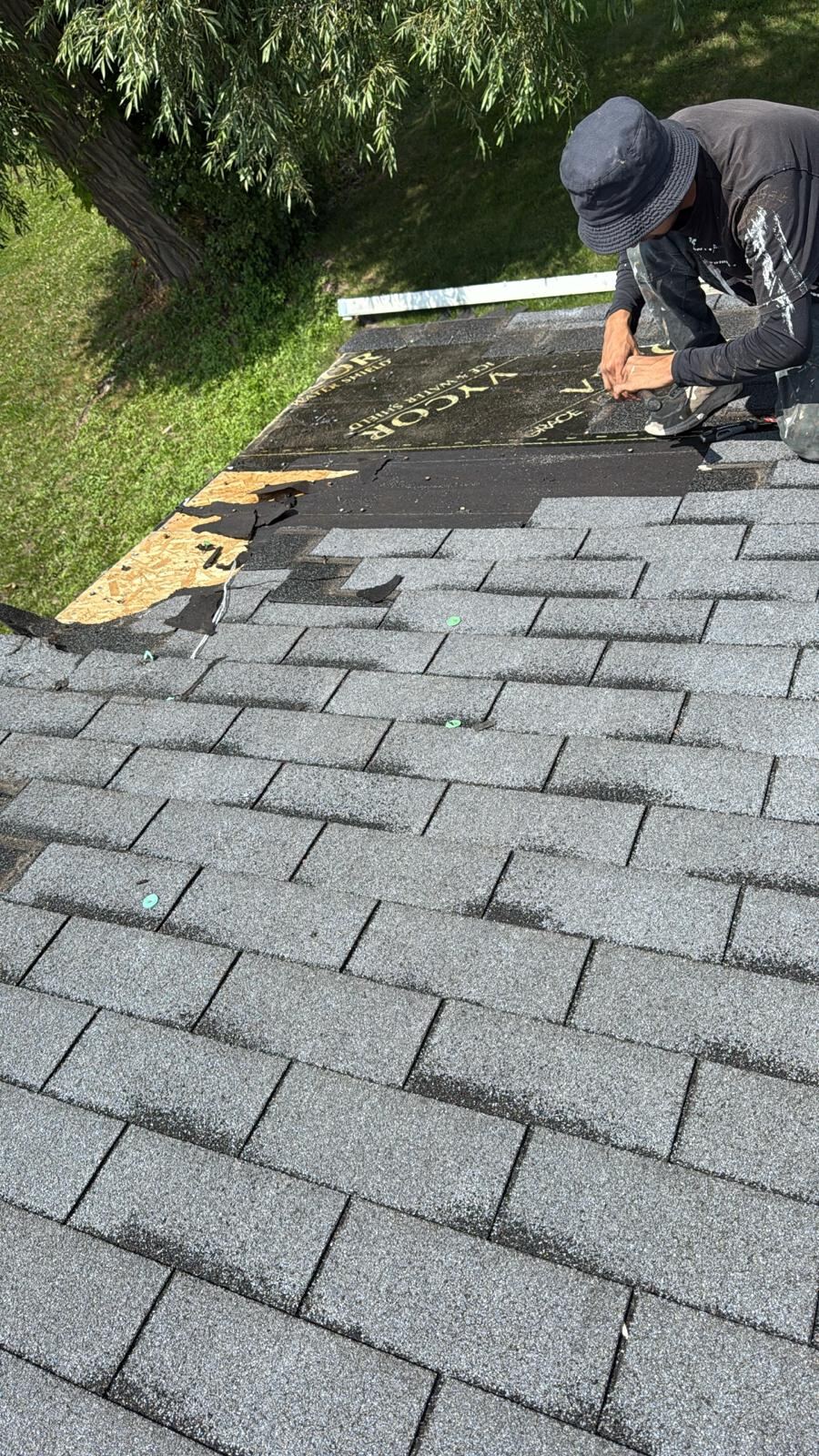 Kelly Construction crew member installing roofing materials